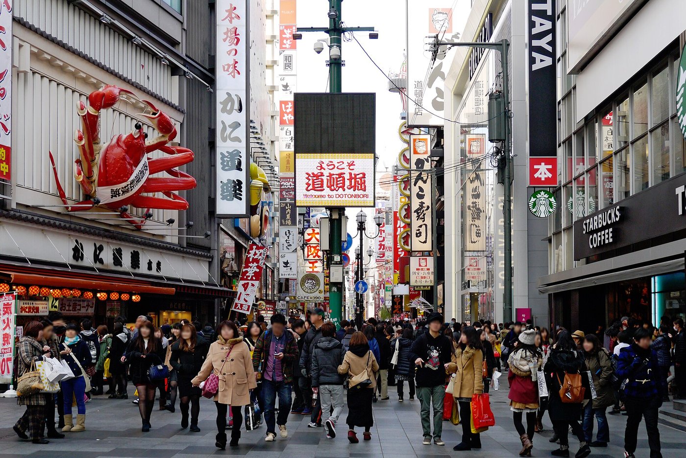 The Dotonbori restaurant street in daylight, the giant crab sign above the shopfronts