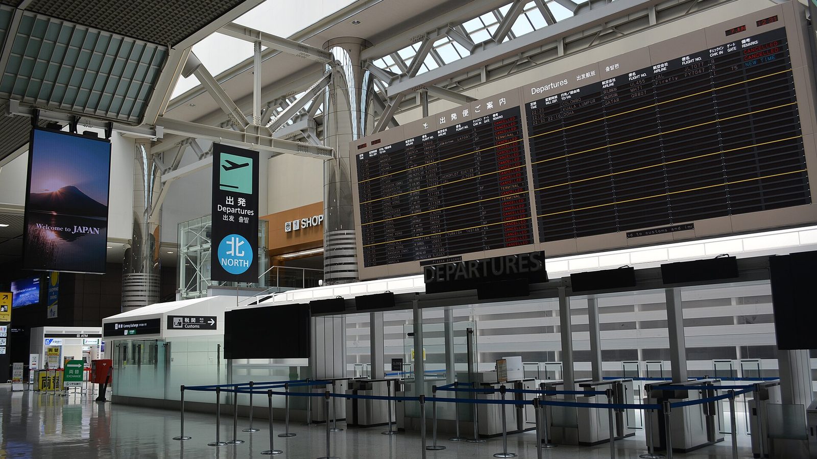 Departure hall at Narita Airport with check-in counters and flight boards